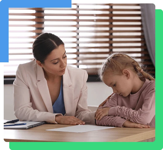Child psychotherapist working with little girl in office