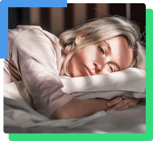 Stressed middle aged woman lying on bed at home and crying